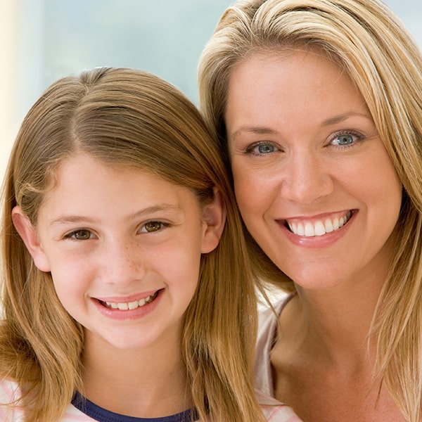 Image of a girl and her mother smilling