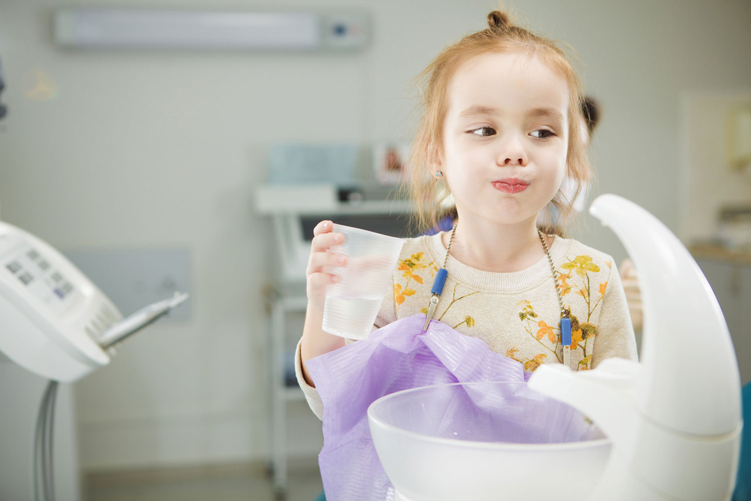 Photo of a little girl rinsing her mouth